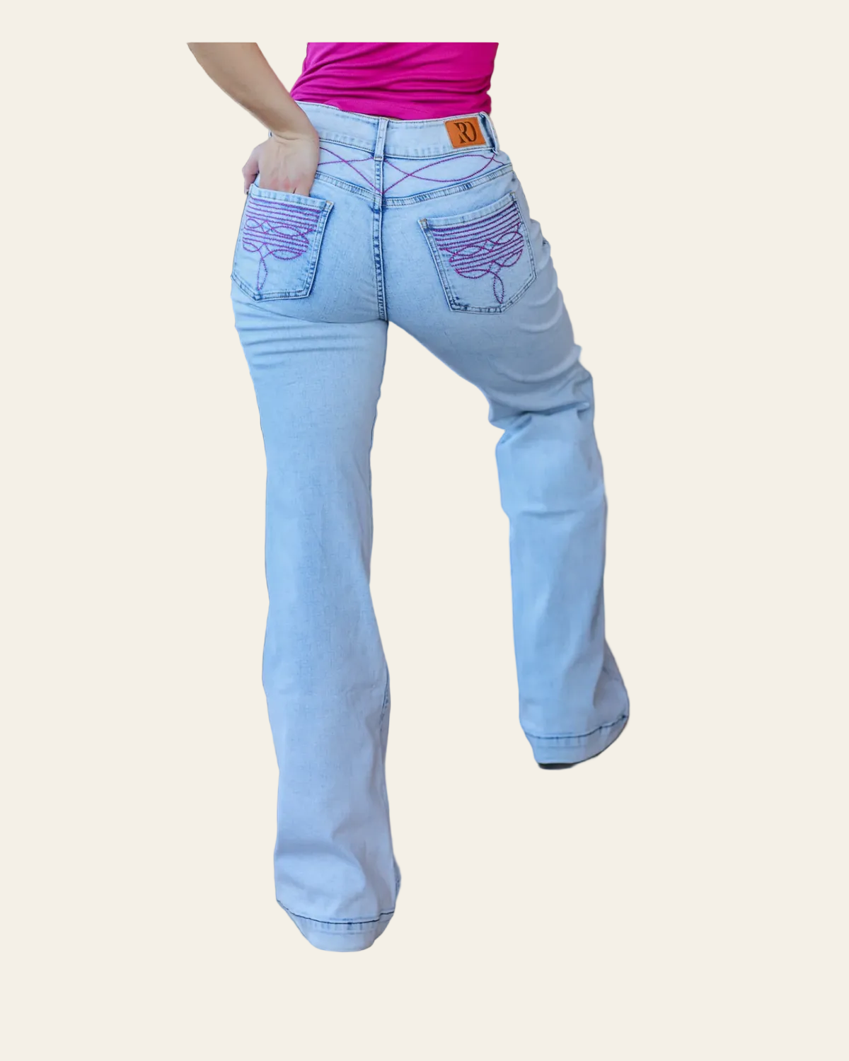 Cheyenne Trousers - Light Wash Pink Pocket on a warm cream background