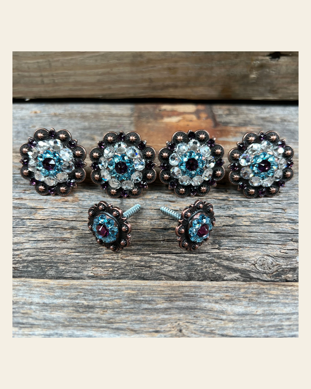 Copper Amethyst Aqua & Clear Saddle Conchos on a warm cream background