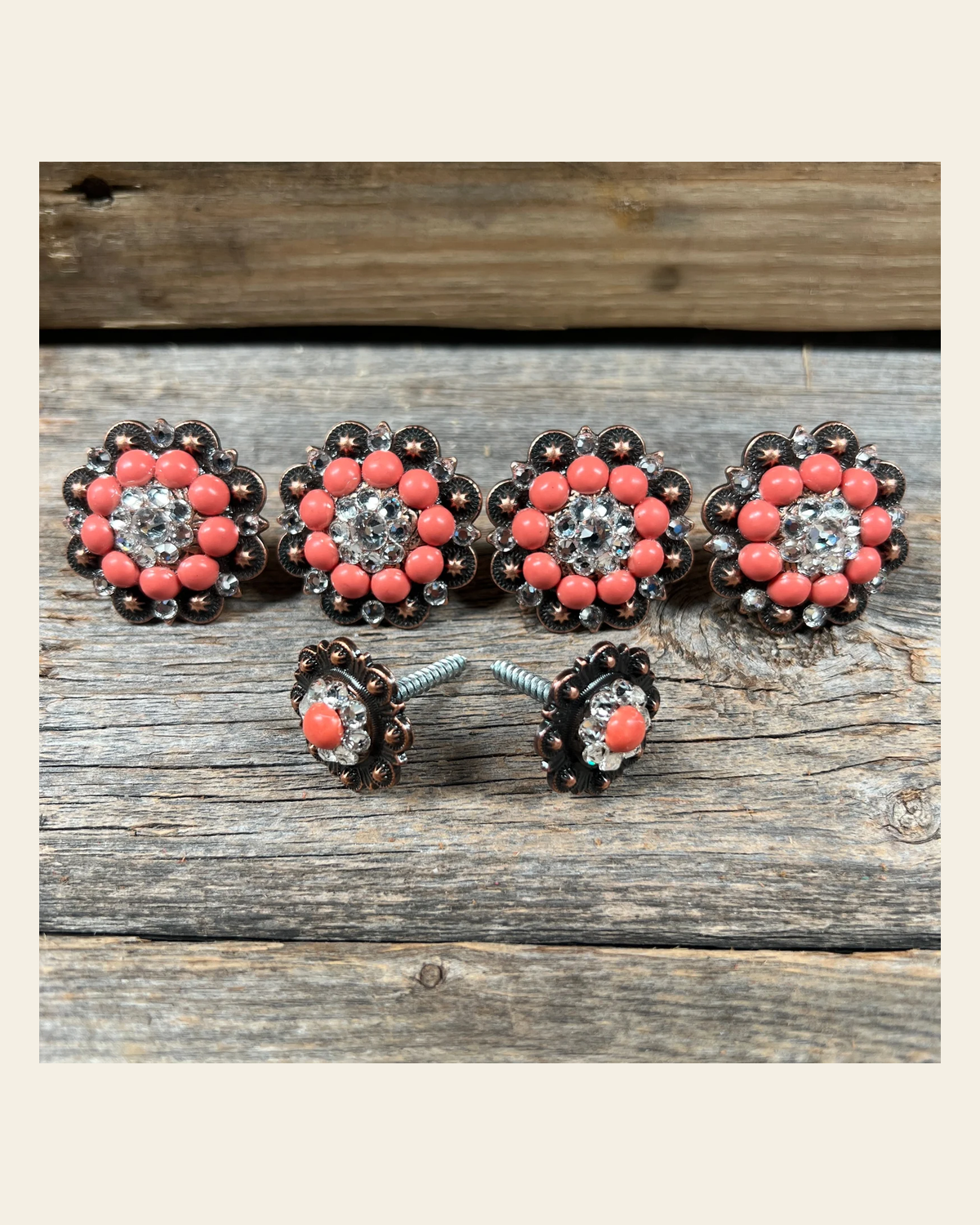 Copper Fashion Coral and Clear Saddle Conchos on a warm cream background