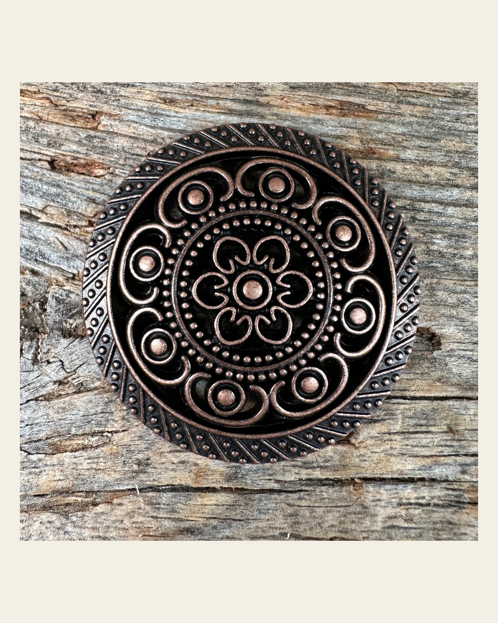 Copper Intricate Engraved Concho 1.5" W224L on a warm cream background