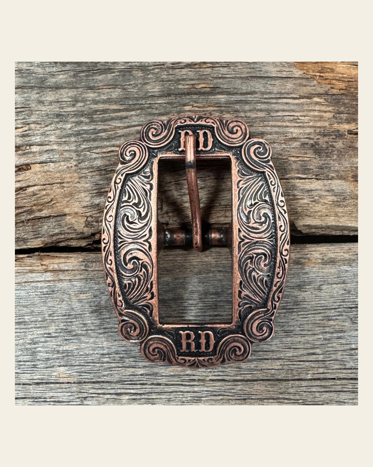 Copper RD Cart Buckle W218B on a warm cream background
