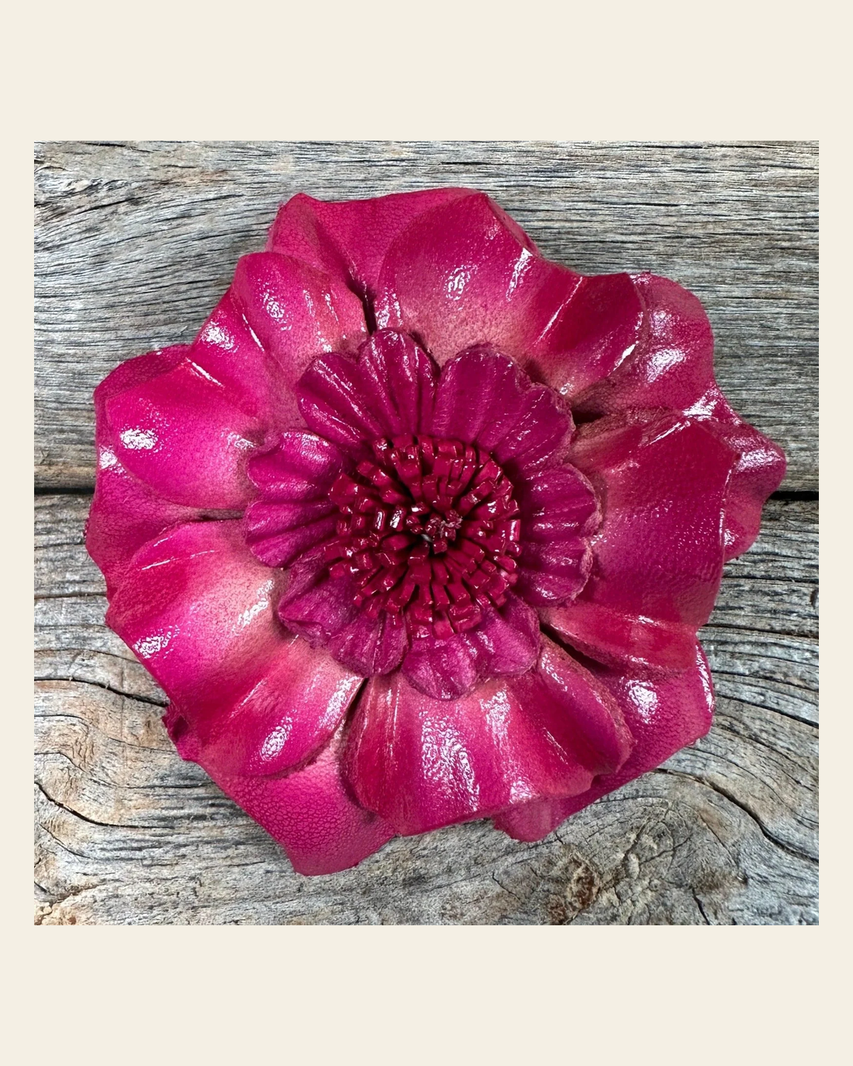 Hot Pink Carnation Leather Flower on a warm cream background