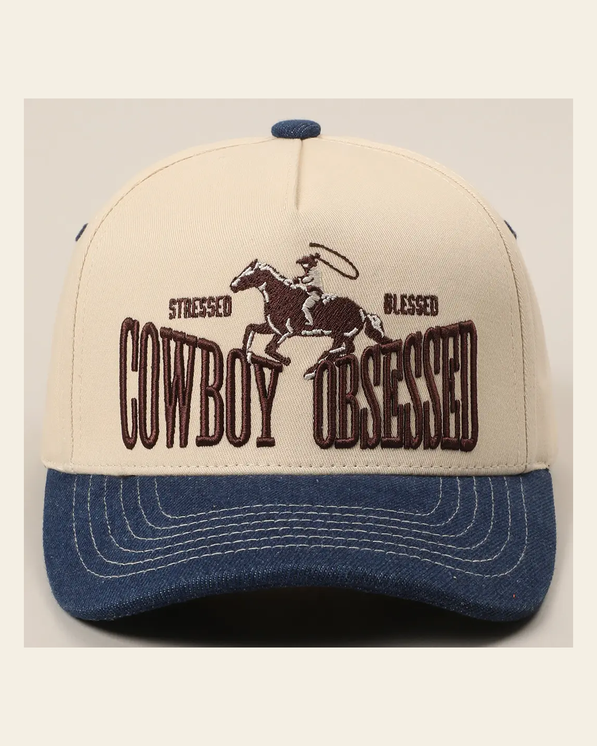 Cowboy Obsessed Trucker | Cap on a warm cream background