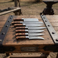7-Piece Damascus Steel Kitchen Knife Collection with Flowing Water Pattern Blades.