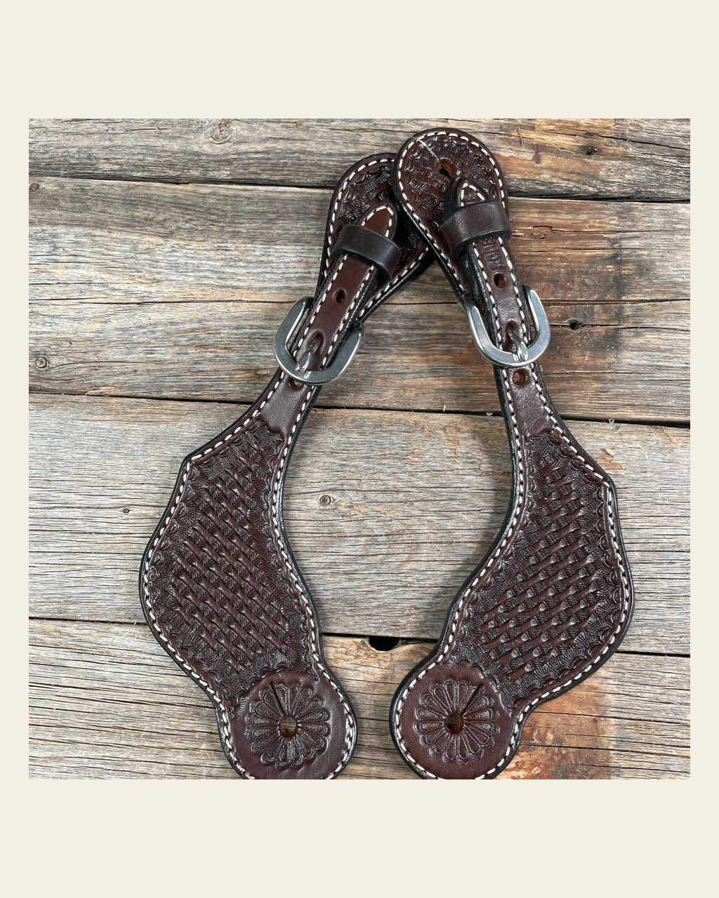Dark Oil Genuine Leather Basketweave Tooled Spur Straps on a warm cream background