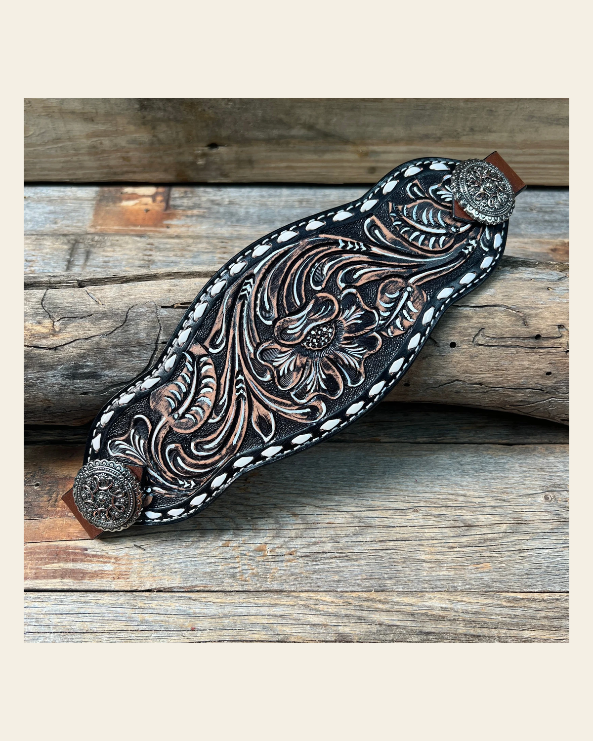 Dark Oil Buckstitch Bronc Noseband With Flowers and Loops Conchos on a warm cream background