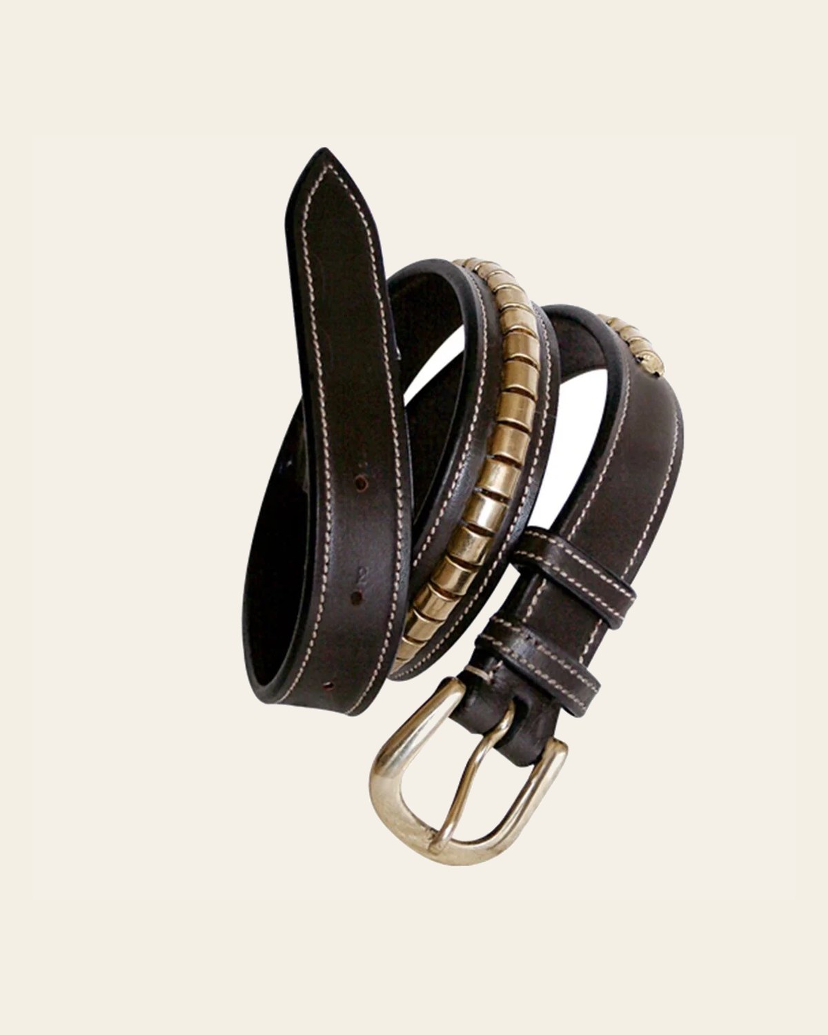 ExionPro Brass Clincher Belts on a warm cream background