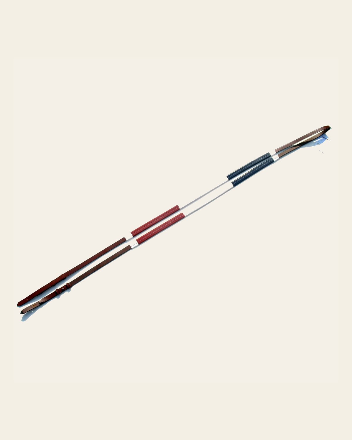 ExionPro Tri-Colour Training Rubber Reins on a warm cream background