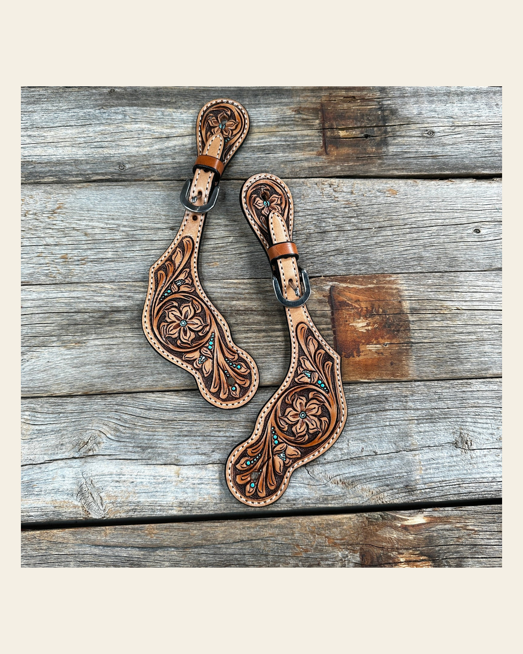 Floral and Teal Dot Tooled Spur Straps on a warm cream background
