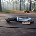 Gut hook knife with wood and brass handle.