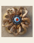 Gold Lotus Flower With Antique Silver Fire Opal and Aqua 1" Concho on a warm cream background