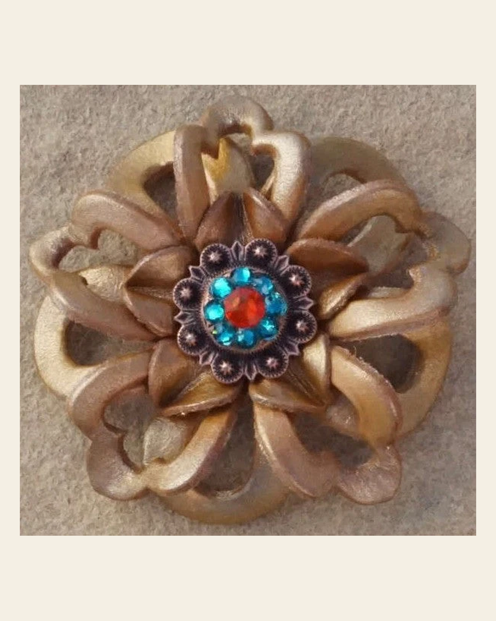 Gold Lotus Flower With Copper Fire Opal and Teal 1" Concho on a warm cream background