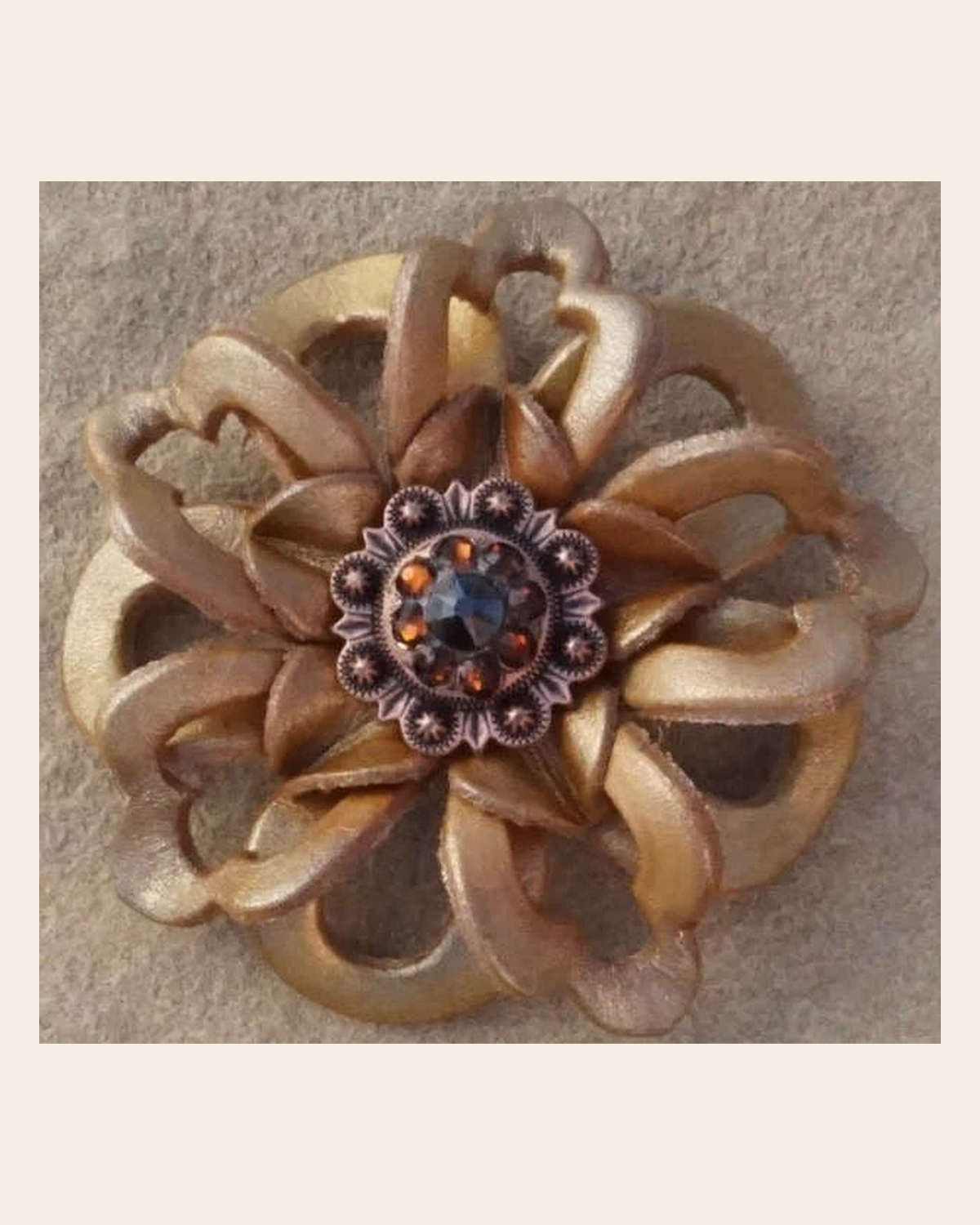 Gold Lotus Flower With Copper Jet and Topaz 1" Concho on a warm cream background