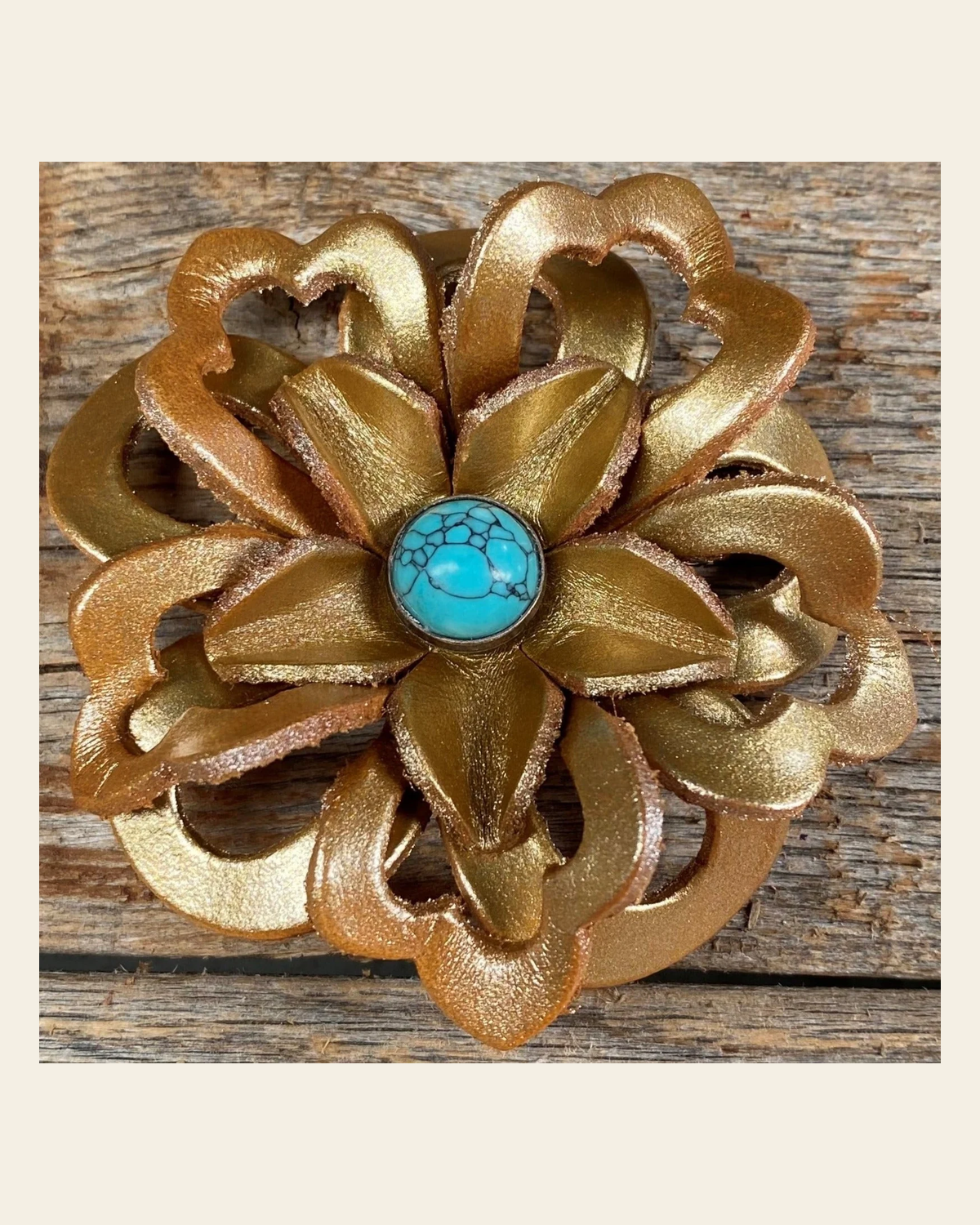 Gold Lotus Flower With Round Turquoise Cabochon on a warm cream background