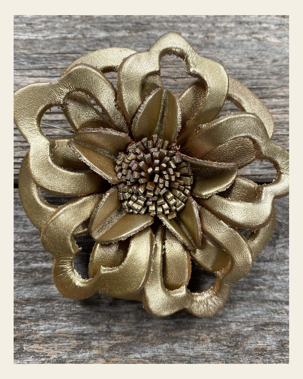 Gold Lotus Leather Flower on a warm cream background