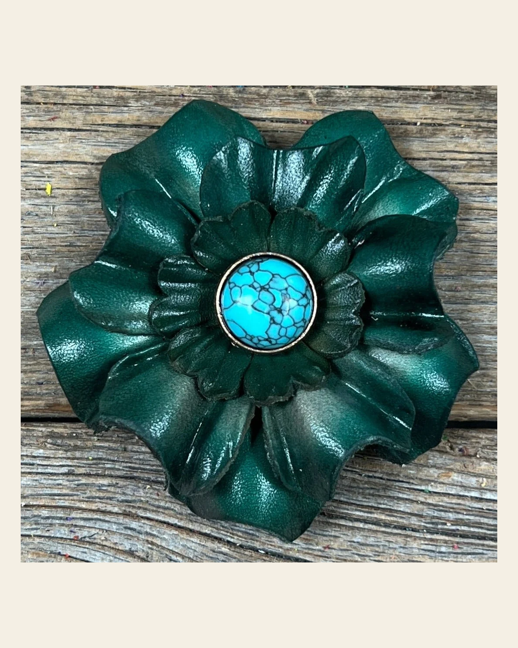 Green Carnation Flower With Round Turquoise Cabochon on a warm cream background