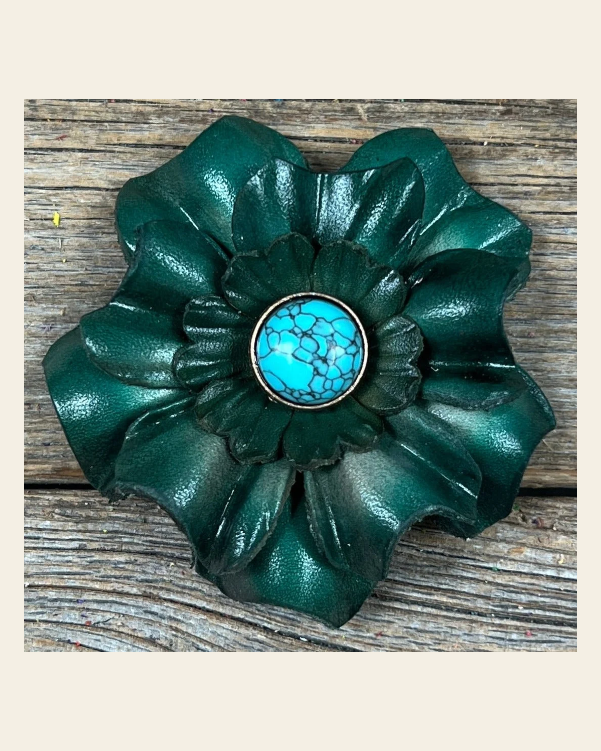Green Carnation Flower With Round Turquoise Cabochon on a warm cream background