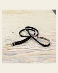 Halter Ego® Black Leather Safari Dog Leash on a warm cream background