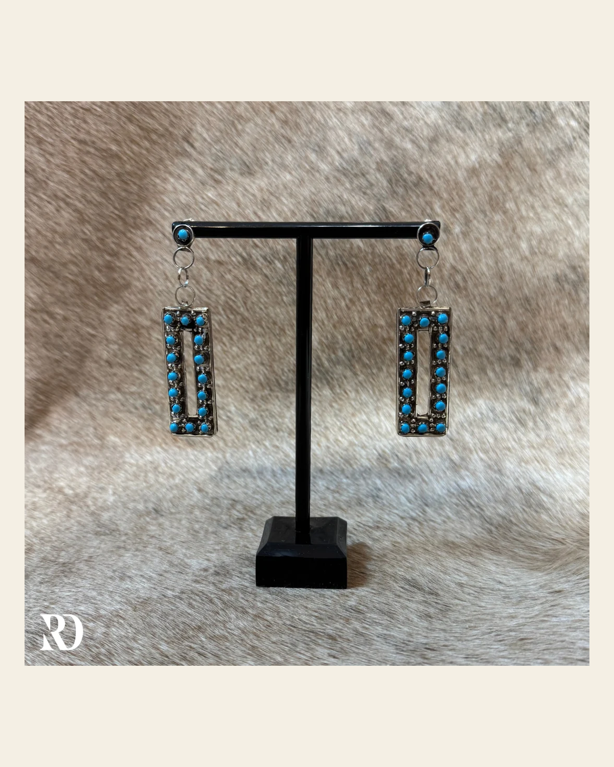 Handmade Zuni Turquoise Rectangle Earrings By Joan Shema on a warm cream background