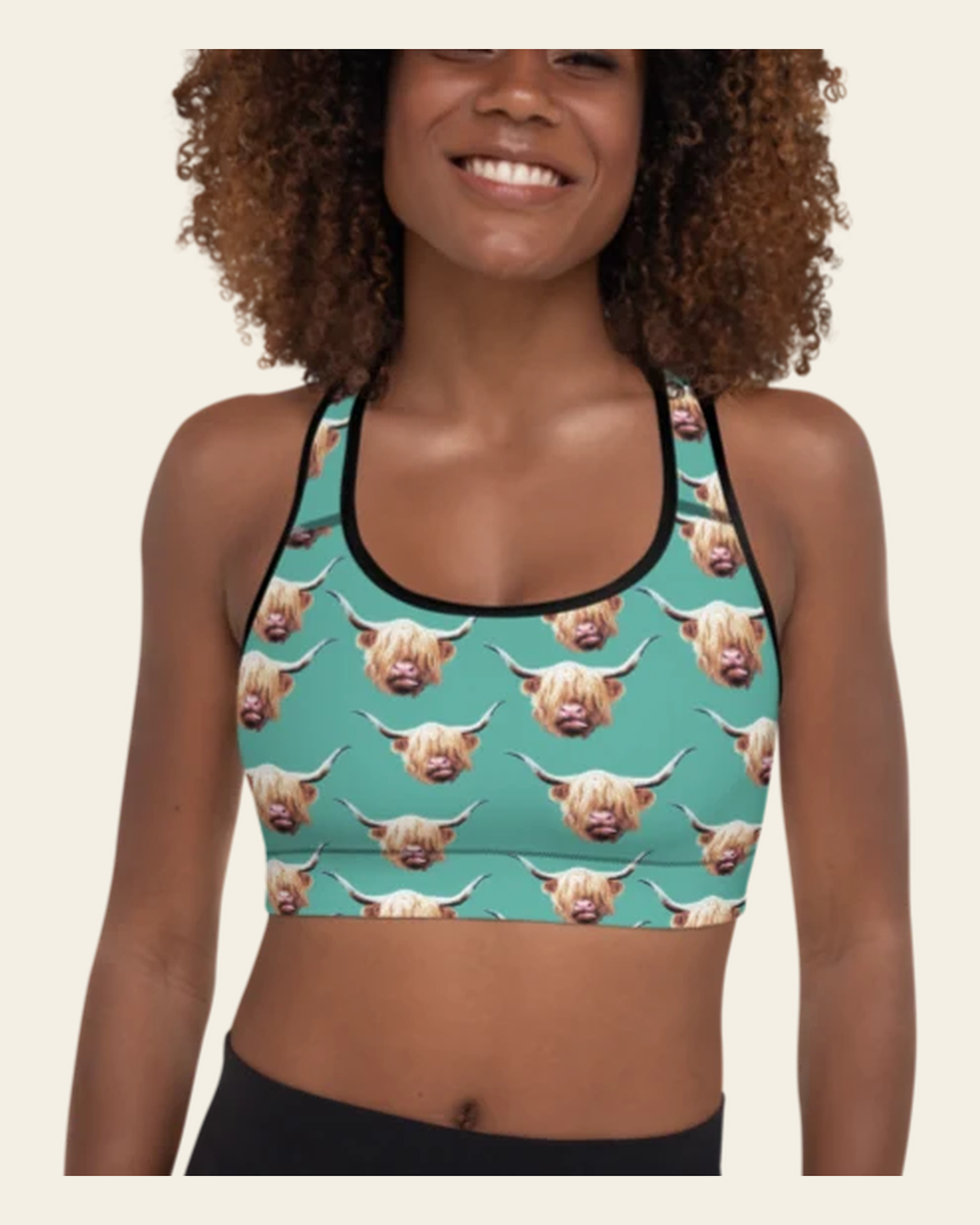 Highland Cow Sports Bra on a warm cream background
