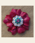Hot Pink Carnation Flower With Bright Silver Pink & Teal 1" Concho on a warm cream background