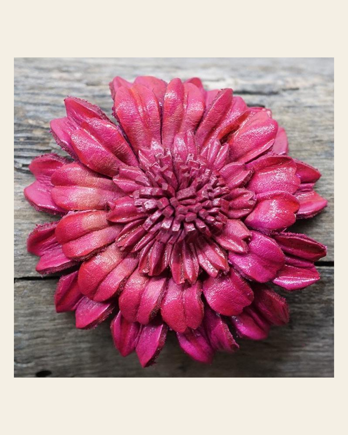 Hot Pink Daisy Leather Flower on a warm cream background