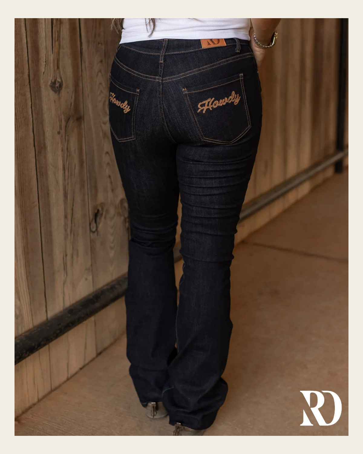 Howdy Bootcut - Dark Wash on a warm cream background