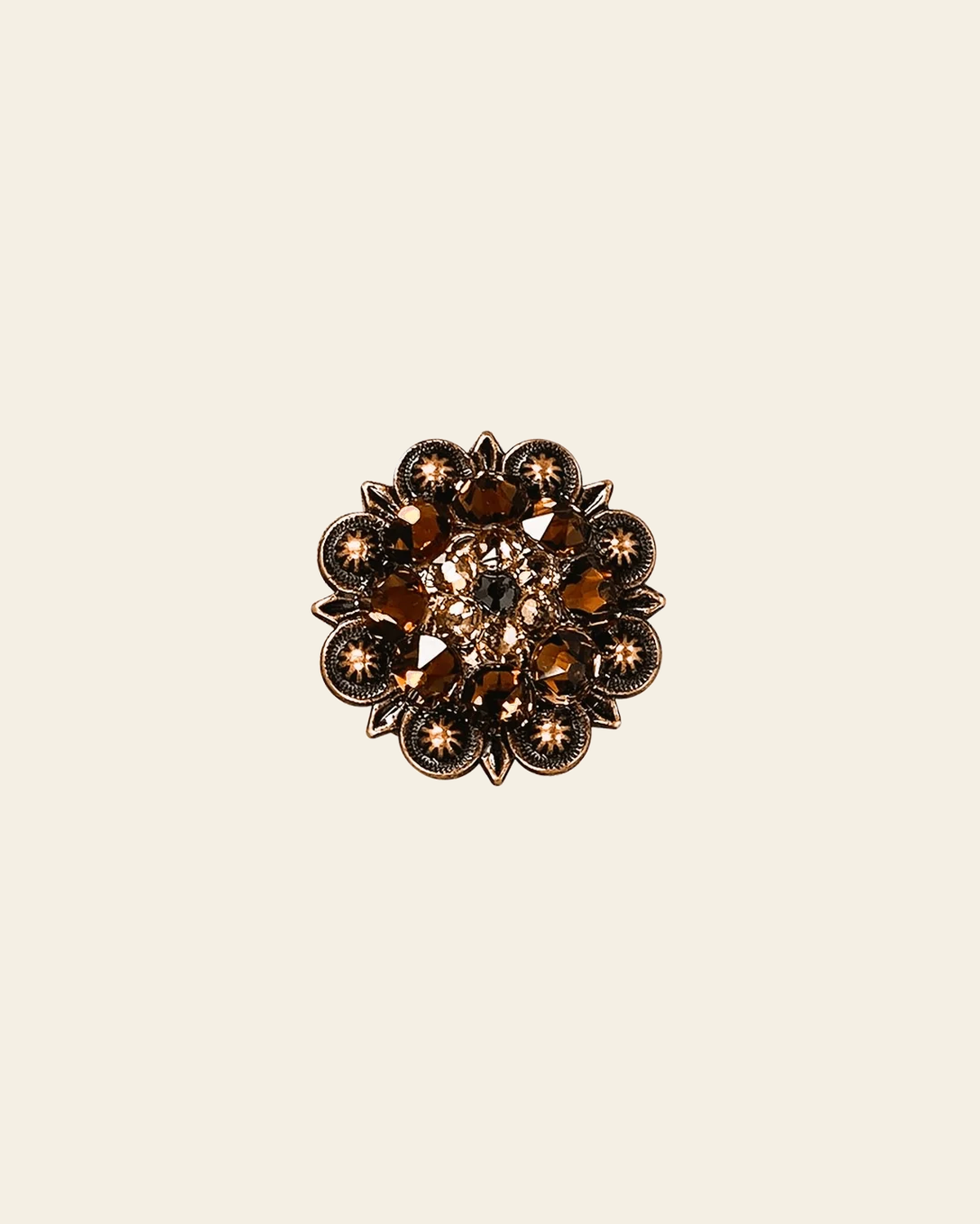 Jet Champagne & Topaz Copper 1.25" European Crystal Concho on a warm cream background