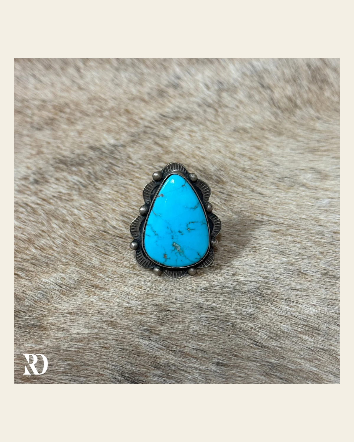 Kingman Turquoise Adjustable Ring By Tia Long on a warm cream background