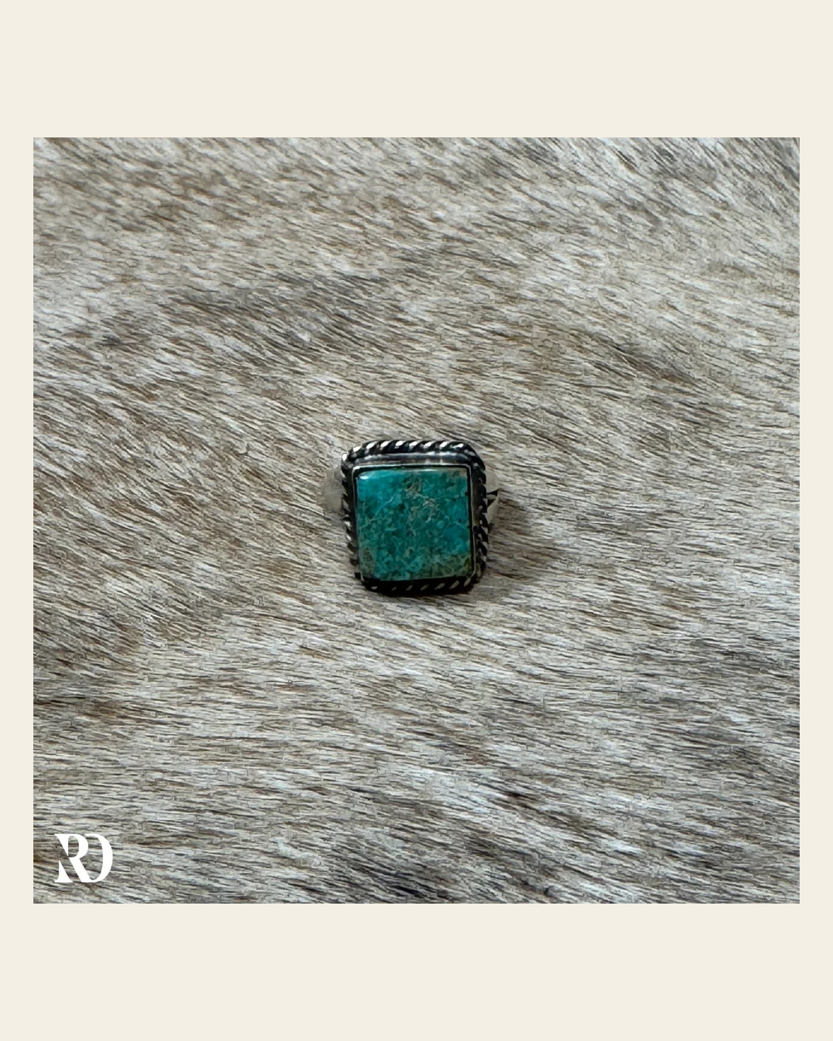Kingman Turquoise Adjustable Square Ring By Donovan Nez on a warm cream background