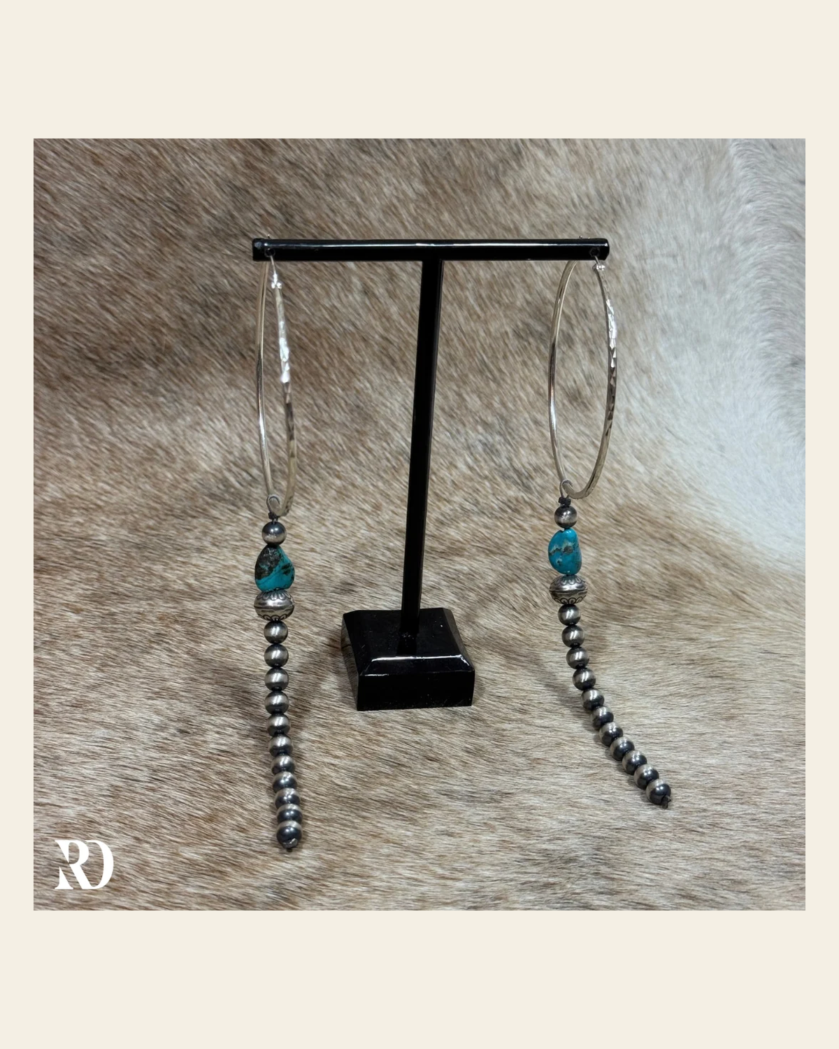 Kingman Turquoise With Strung Navajo Peral Dangle Hoop Earrings By Theresa Skeets on a warm cream background