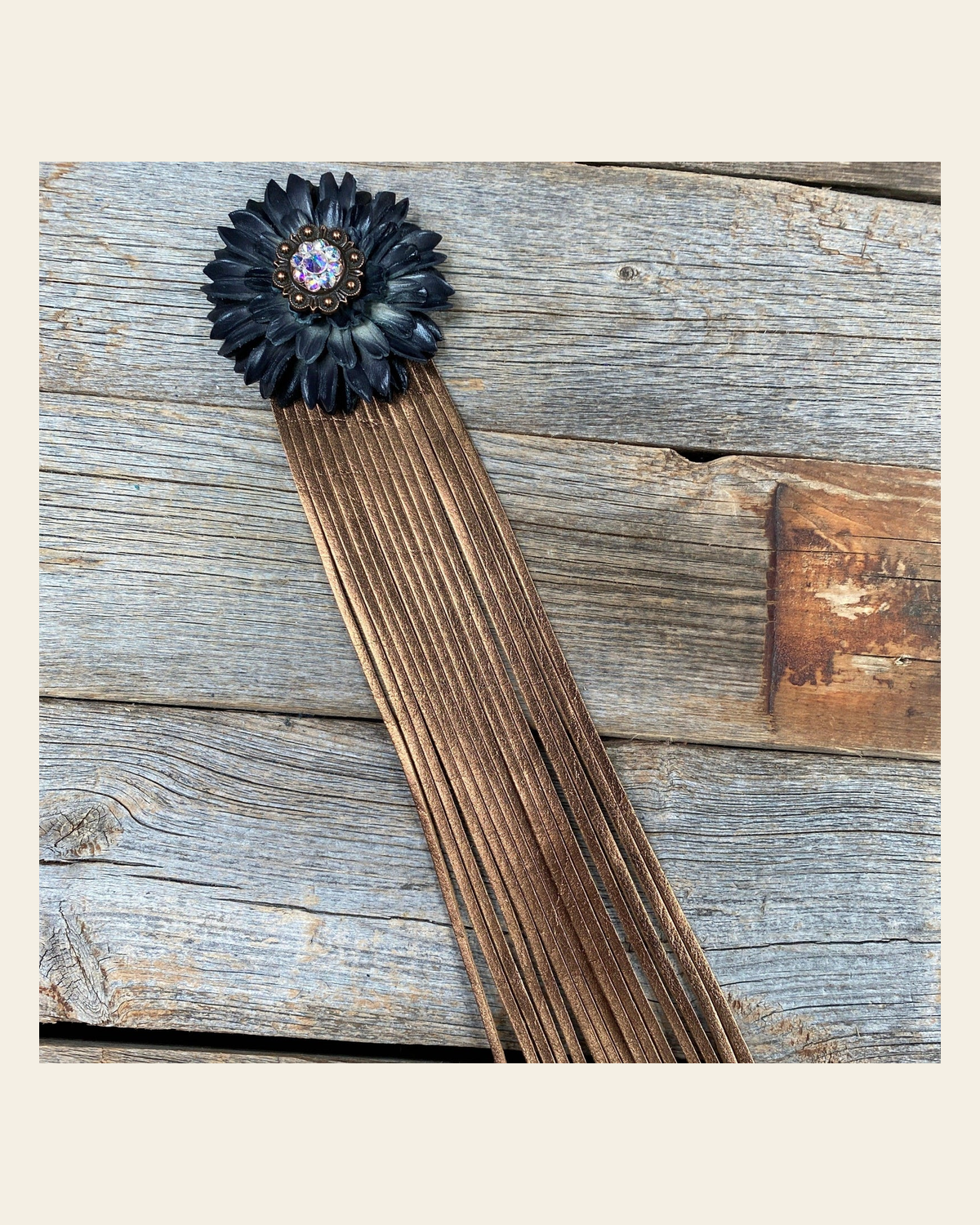 Leather Black Daisy with Copper Fringe on a warm cream background