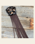 Leather Black Lotus with Brown Fringe on a warm cream background