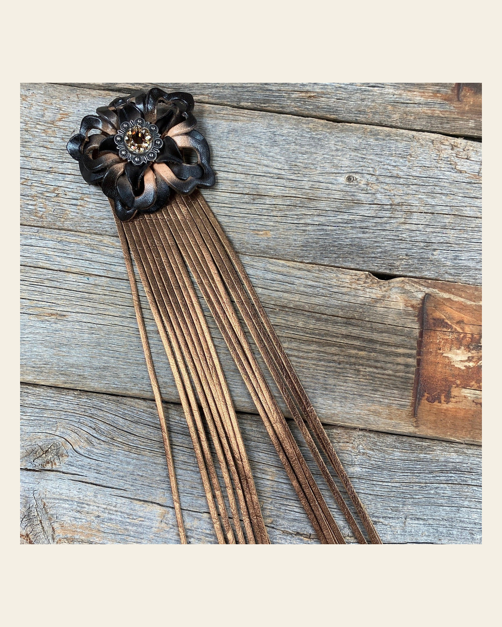 Leather Black Lotus with Copper Fringe on a warm cream background