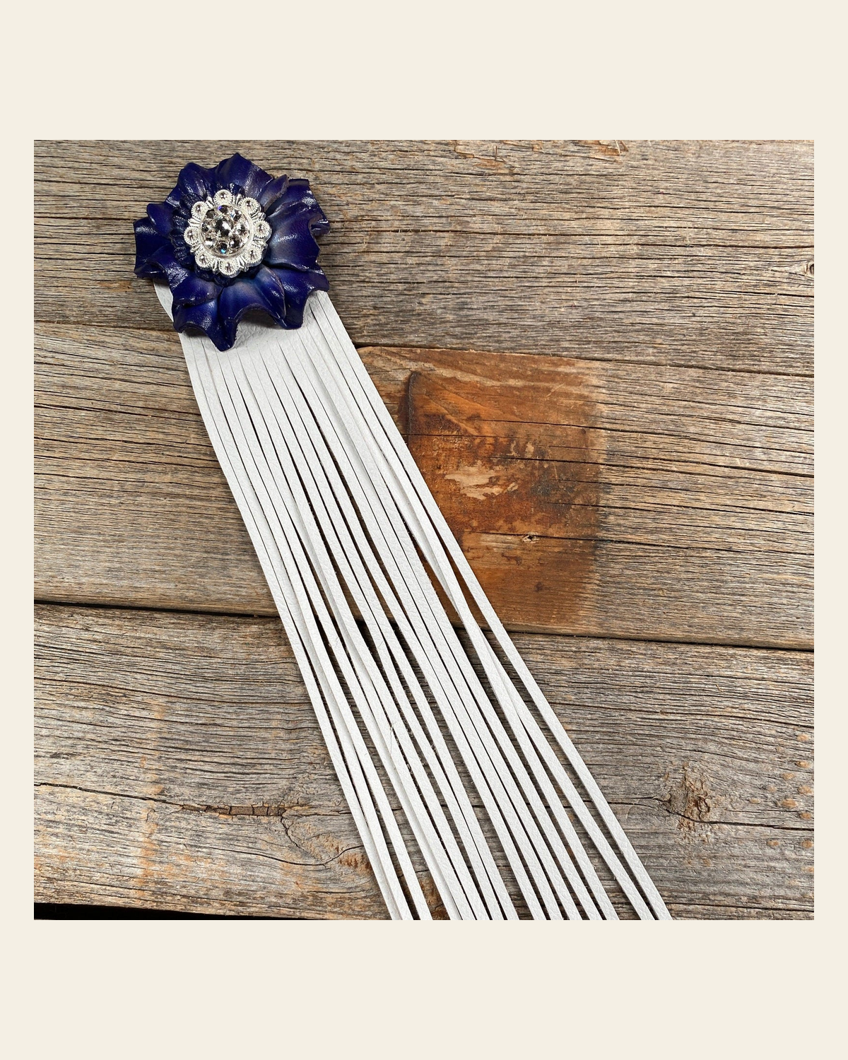 Leather Blue Carnation with White Fringe on a warm cream background