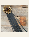 Leather Gold Lotus with Black Fringe on a warm cream background