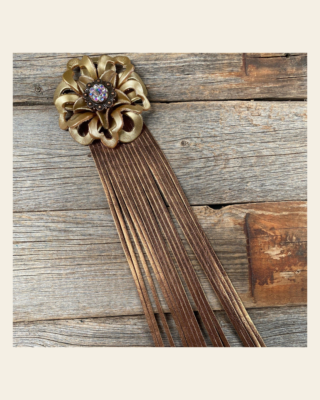 Leather Gold Lotus with Copper Fringe on a warm cream background