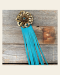 Leather Gold Lotus with Turquoise Fringe on a warm cream background