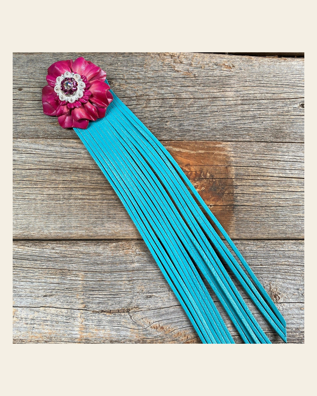 Leather Pink Carnation with Turquoise Fringe on a warm cream background