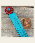 Leather Red Carnation with Turquoise Fringe on a warm cream background