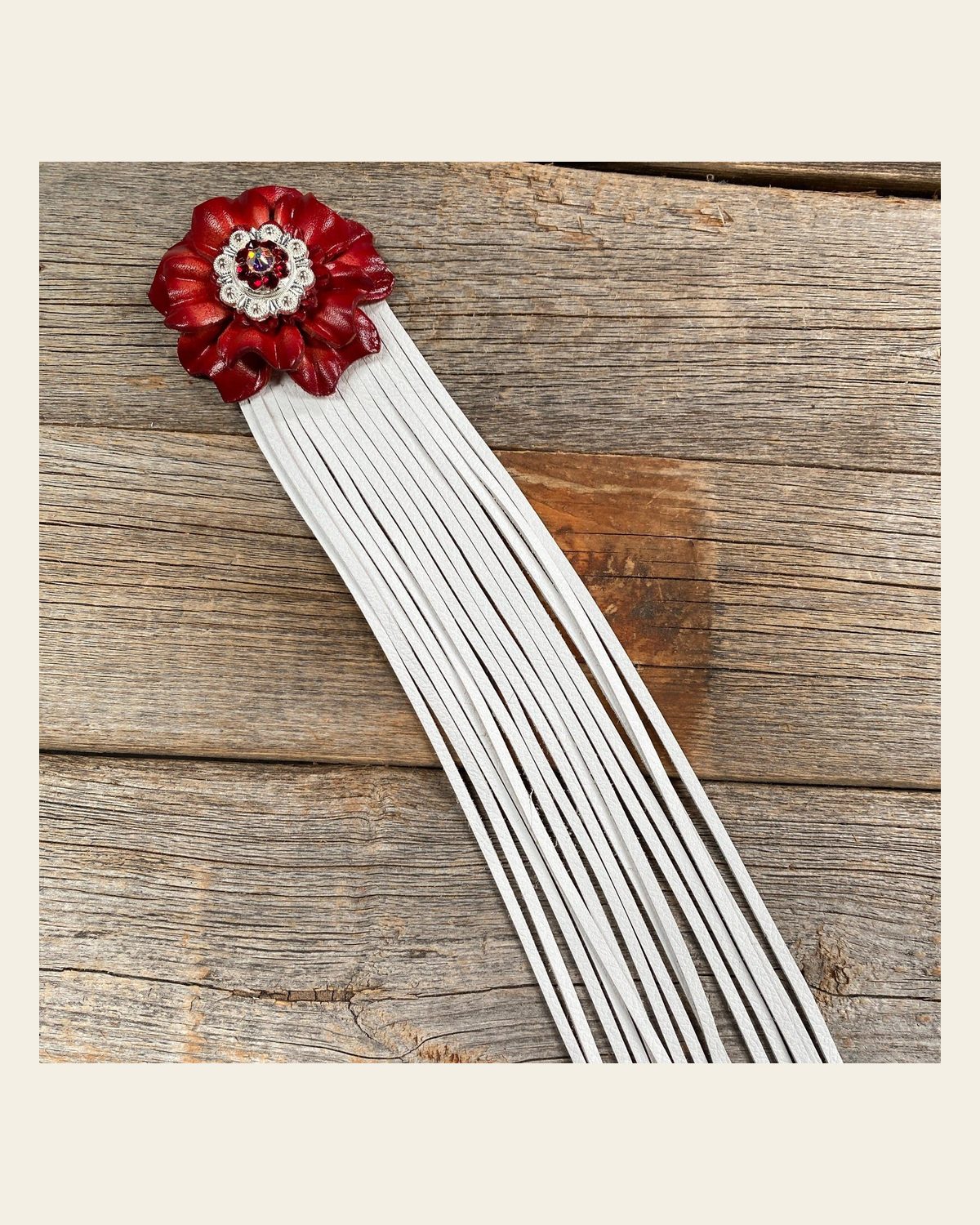 Leather Red Carnation with White Fringe on a warm cream background