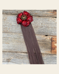 Leather Red Gardenia with Brown Fringe on a warm cream background