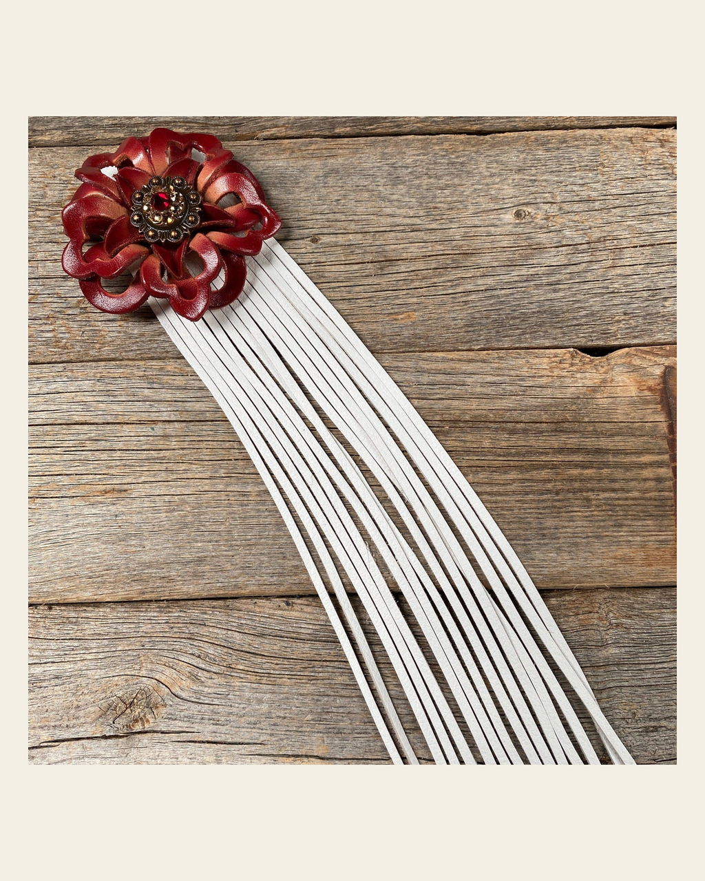 Leather Red Lotus with White Fringe on a warm cream background