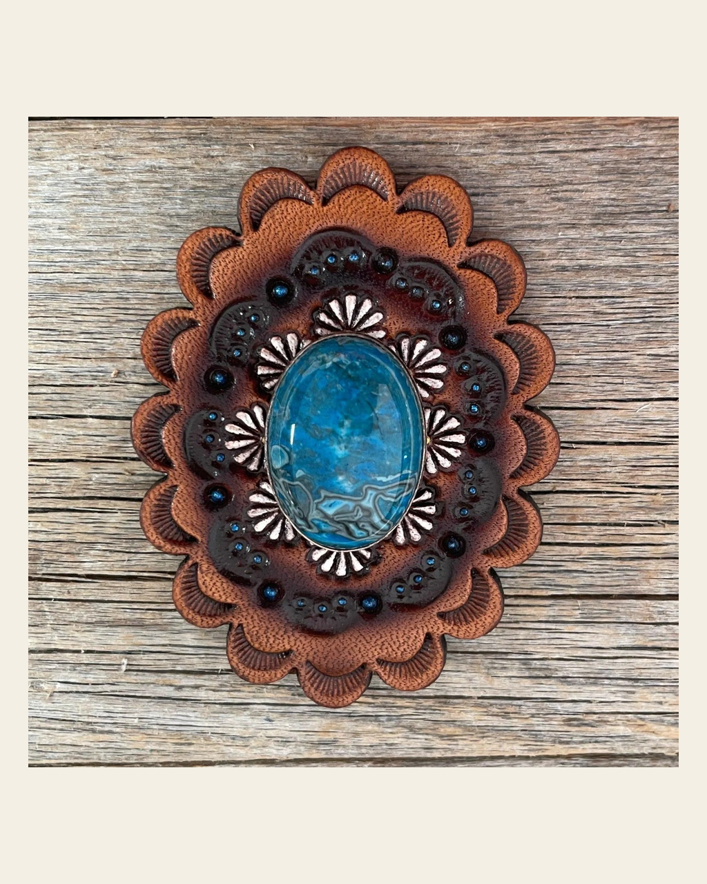 Leather Rosette with Blue Cabochon Western Concho R102CABBL on a warm cream background