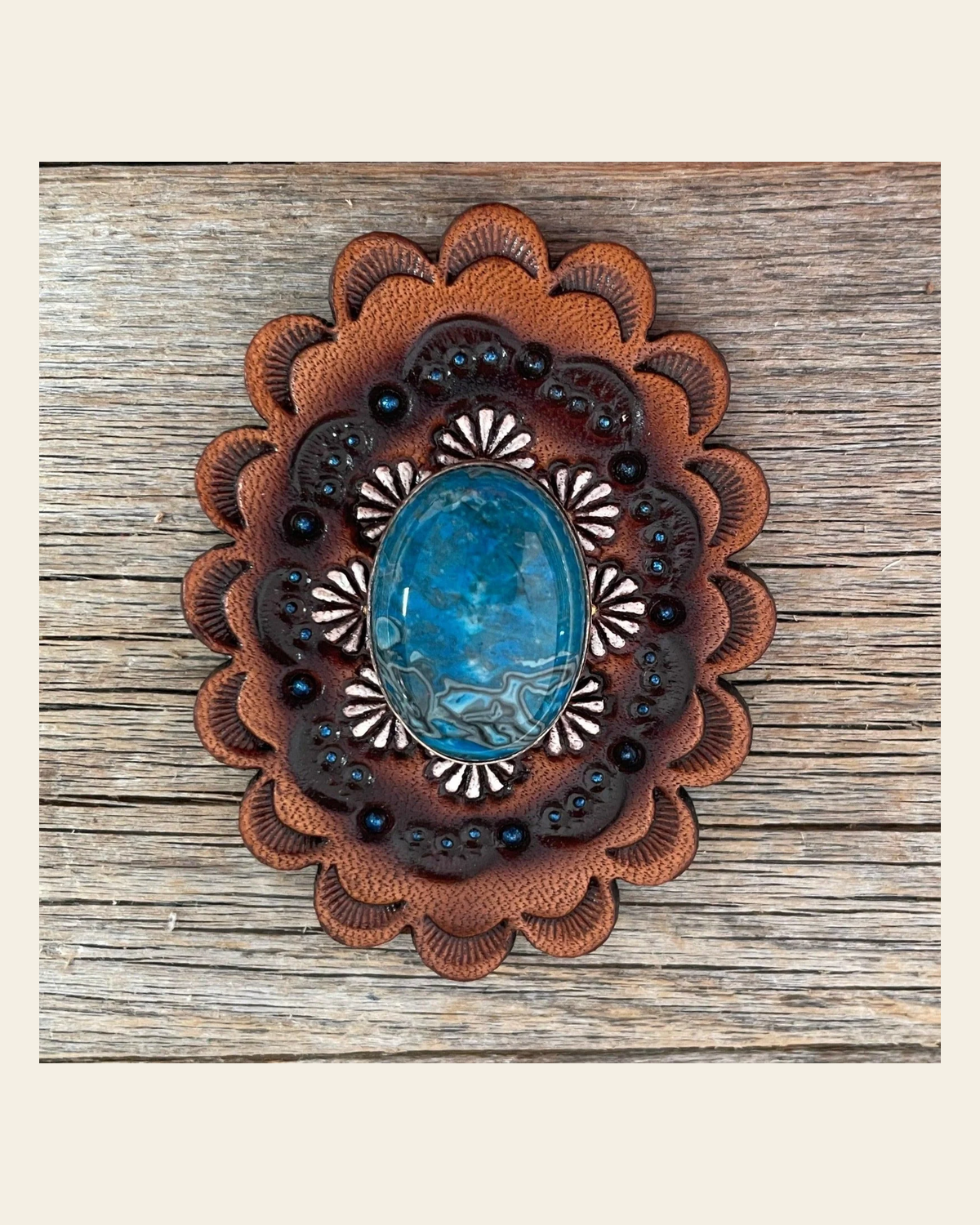 Leather Rosette with Blue Cabochon Western Concho R102CABBL on a warm cream background
