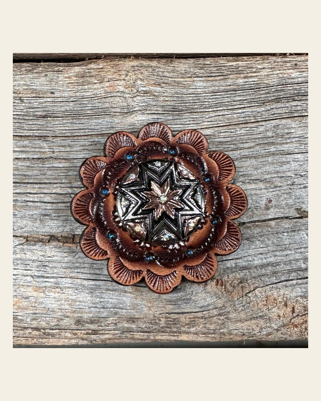 Leather Rosette with Starburst Western Concho R111W185S on a warm cream background