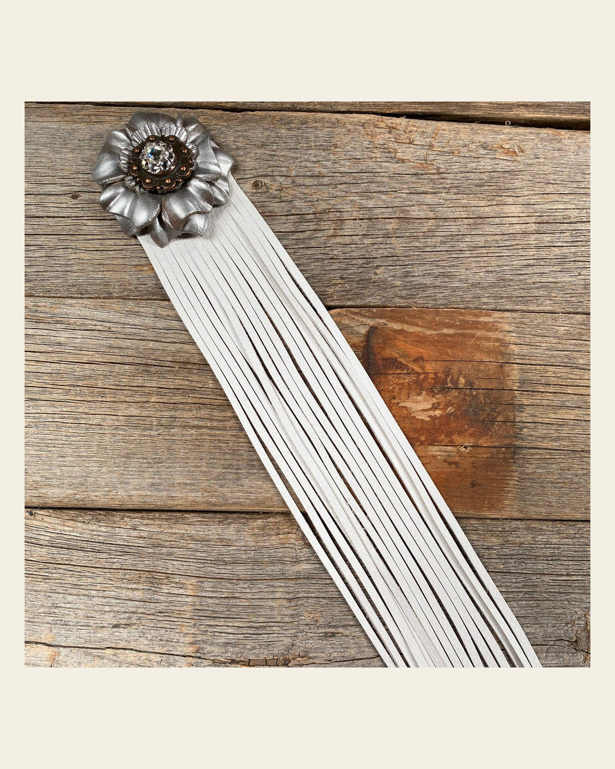 Leather Silver Carnation with White Fringe on a warm cream background