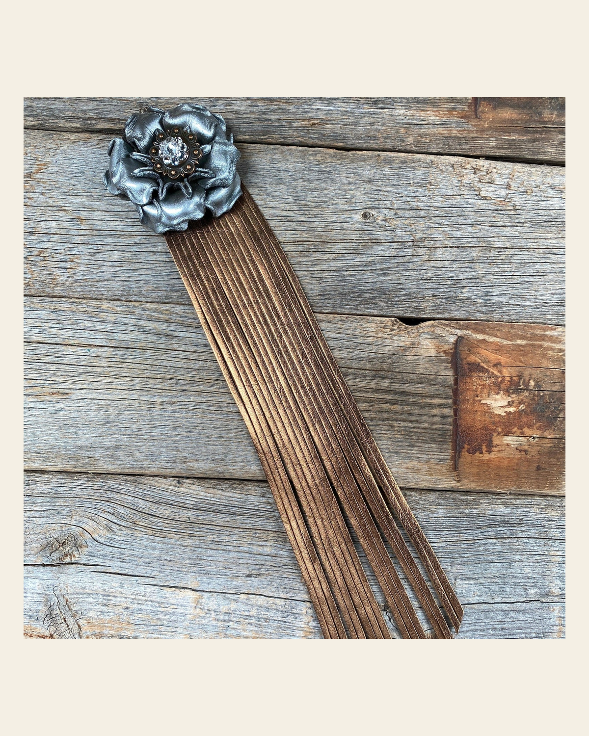 Leather Silver Gardenia with Copper Fringe on a warm cream background