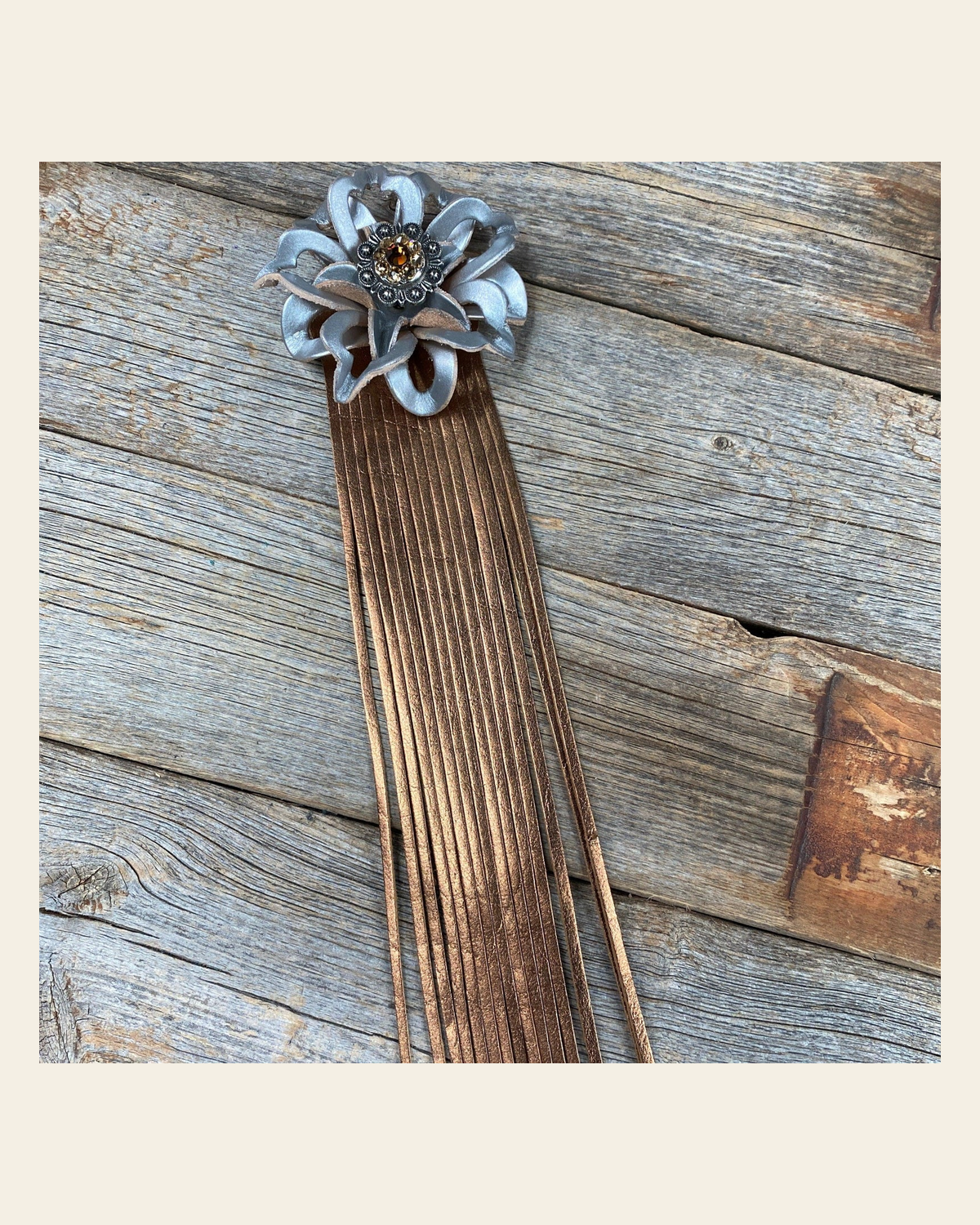 Leather Silver Lotus with Copper Fringe on a warm cream background