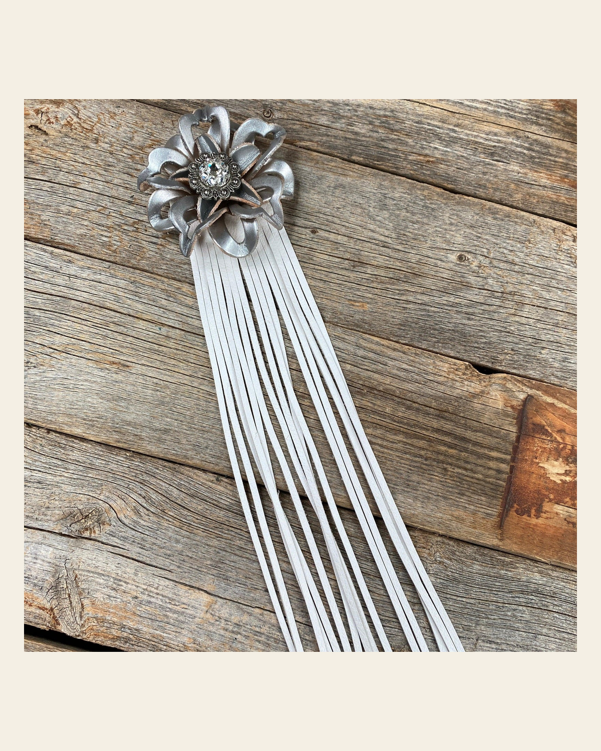 Leather Silver Lotus with White Fringe on a warm cream background